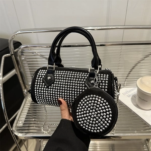 Sparkling black cylinder bag with rhinestones, silver chain strap and mini coin purse