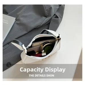 Interior view of white leather shoulder bag showing capacity for lipstick and card holder