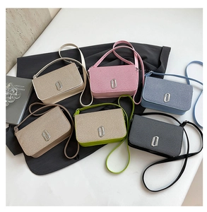 Detailed view of rectangle woven crossbody bags in six colors with silver metal buckles