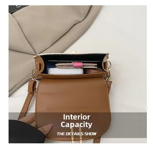Interior view showing the large capacity of the caramel leather woven straw shoulder bag