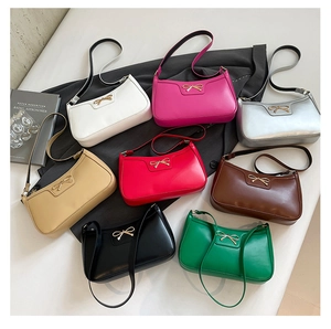 Top view of eight hobo bags in various colors featuring metallic bow details