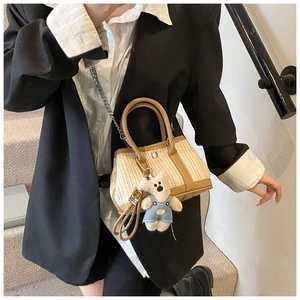 Mini straw tote with leather trim and cute bear charm shown with a metal chain strap