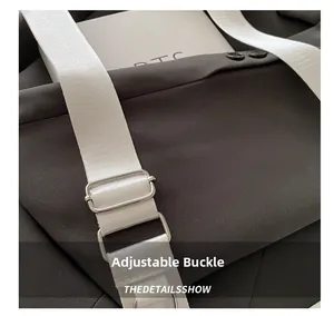 Close-up of adjustable silver buckle and woven strap on a transparent PVC bag