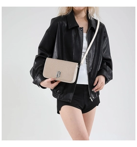 Detailed view of women's color-block crossbody bag with glitter texture and metal buckle