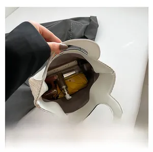 Interior view showing the large capacity and magnetic buckle of this woven tote bag