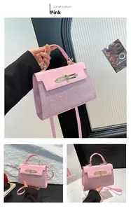 Detailed view of a pink crossbody bag featuring glitter texture and a gold lock