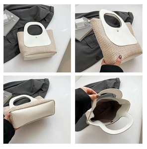 Detail view showing woven texture, white PU leather handles and base of straw tote bag