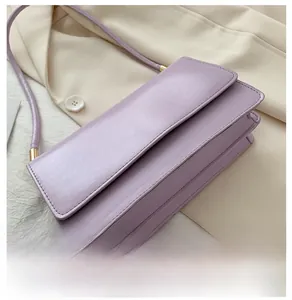 Detail view of the refined bottom structure and matte leather texture of the purple bag