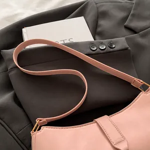 Close-up view of the smooth pink strap on a minimalist summer underarm shoulder bag