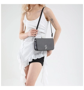 Detail of grey textured flap crossbody bag featuring silver Double J metal logo buckle