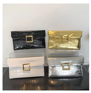 Detail of four stone-embossed envelope clutches with large gold square buckles