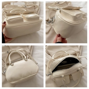 Detail view of cream patent leather tote with multiple pockets and adjustable strap
