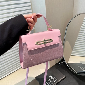 Pink patchwork handbag with sequins and golden turn-lock shown in a lifestyle setting