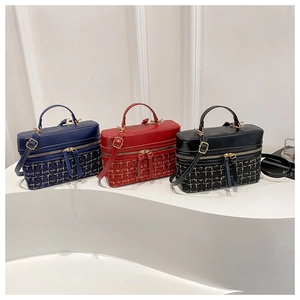 Detailed view of tweed and leather crossbody bags in navy, burgundy, and black finishes