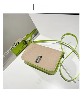 Detail of green PU leather crossbody bag with beige woven flap and metal chain buckle