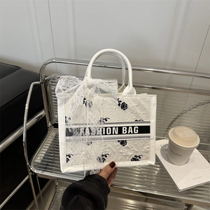 White tote bag with 3D embossed rose pattern and black and white striped detail