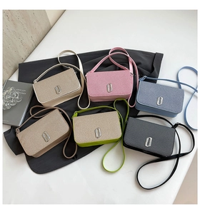 Close-up of multi-color crossbody bags with glitter texture and silver metal locks