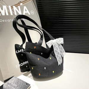 Black canvas tote bag with floral tulip embroidery and white lace bow decoration