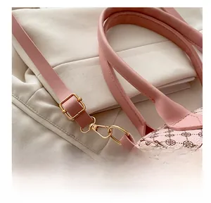 Detail of pink leather shoulder strap with gold-tone buckle and vintage floral print