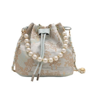 Elegant bucket bag with pearl handle and golden mountain landscape embroidery