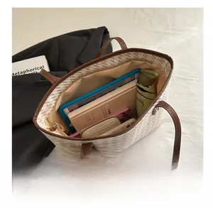Interior view of large capacity woven tote bag showing space for tablet and wallet