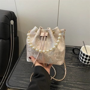 Satin bucket bag with embroidery, large pearl handle and metal chain shoulder strap