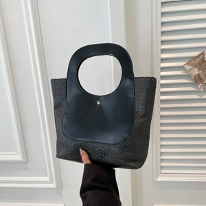 Minimalist black hand-woven straw tote bag with leather contrast and circular handle