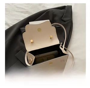 Internal view of the cream leather crossbody bag showing storage for phone and wallet