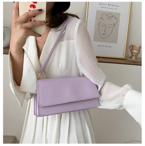 Chic lavender leather shoulder bag shown in an elegant minimalist interior setting
