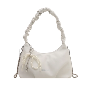 White pleated crescent underarm bag with pearl bow and silver heart pendant