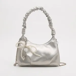 Silver metallic pleated cloud handbag with pearl bow charm and metal chain strap
