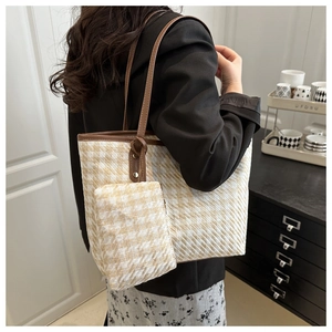 Detail of checkered tote bag with woven texture and matching mini pouch accessory