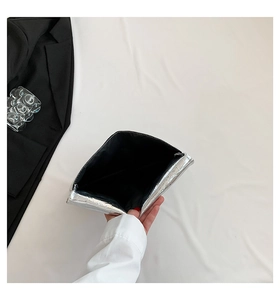 Close-up of silver stone pattern envelope clutch with crocodile texture and black lining