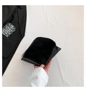 Close-up of black crocodile texture envelope clutch interior with minimalist chic styling