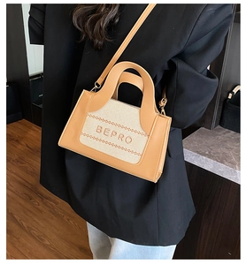 Detail of camel leather and canvas crossbody bag with BEPRO lettering on a female model