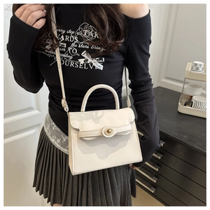 Detail of cream white PU leather crossbody bag with elegant gold metal twist lock buckle