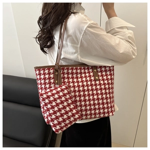 Detail of red and white houndstooth tote bag with matching mini pouch and leather strap