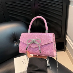 Pink sequin evening handbag with silver rhinestone bow and metal chain strap