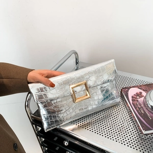 Silver stone pattern envelope clutch bag with gold metal buckle held by hand