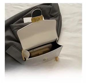 Detailed internal view of the white floral embossed crossbody bag showing storage capacity