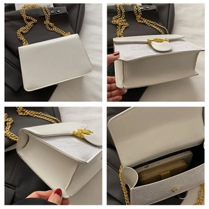 Detail view of white chain bag featuring 3D fish scale texture and gold hardware