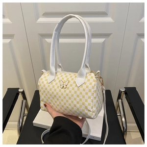Detailed close-up of geometric pattern boston handbag with golden butterfly clasp and strap