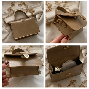 Detail view of khaki square handbag with gold chain strap and interior storage space