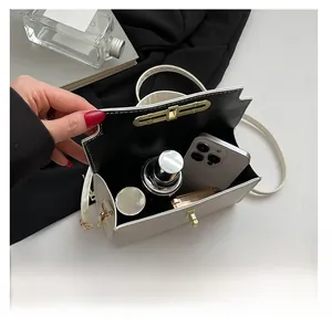 Detail shot of the spacious interior of the vintage white crossbody bag with golden lock