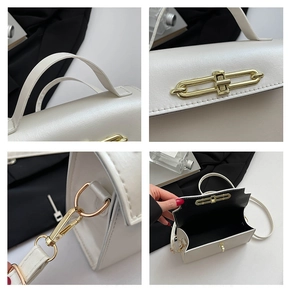 Detail of elegant beige handbag featuring golden twist-lock closure and leather texture