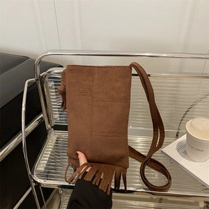 Brown faux suede bohemian crossbody bag with tassel fringe and stitch detailing
