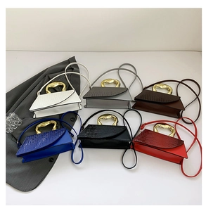 Multiple colors of crocodile pattern crossbody bags with unique gold metal handles