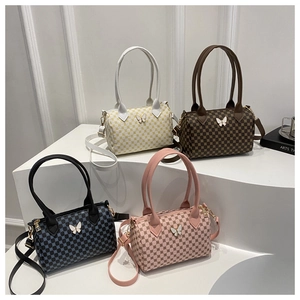Detailed collection of four checkered Boston bags with butterfly ornaments and handles