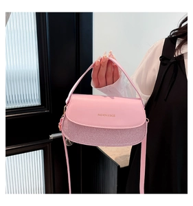 Detailed view of pink crossbody box bag featuring glitter texture and Fashion & Bags text