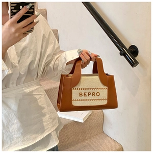 Detail of Korean style tote bag with brown leather contrast and BEPRO logo branding